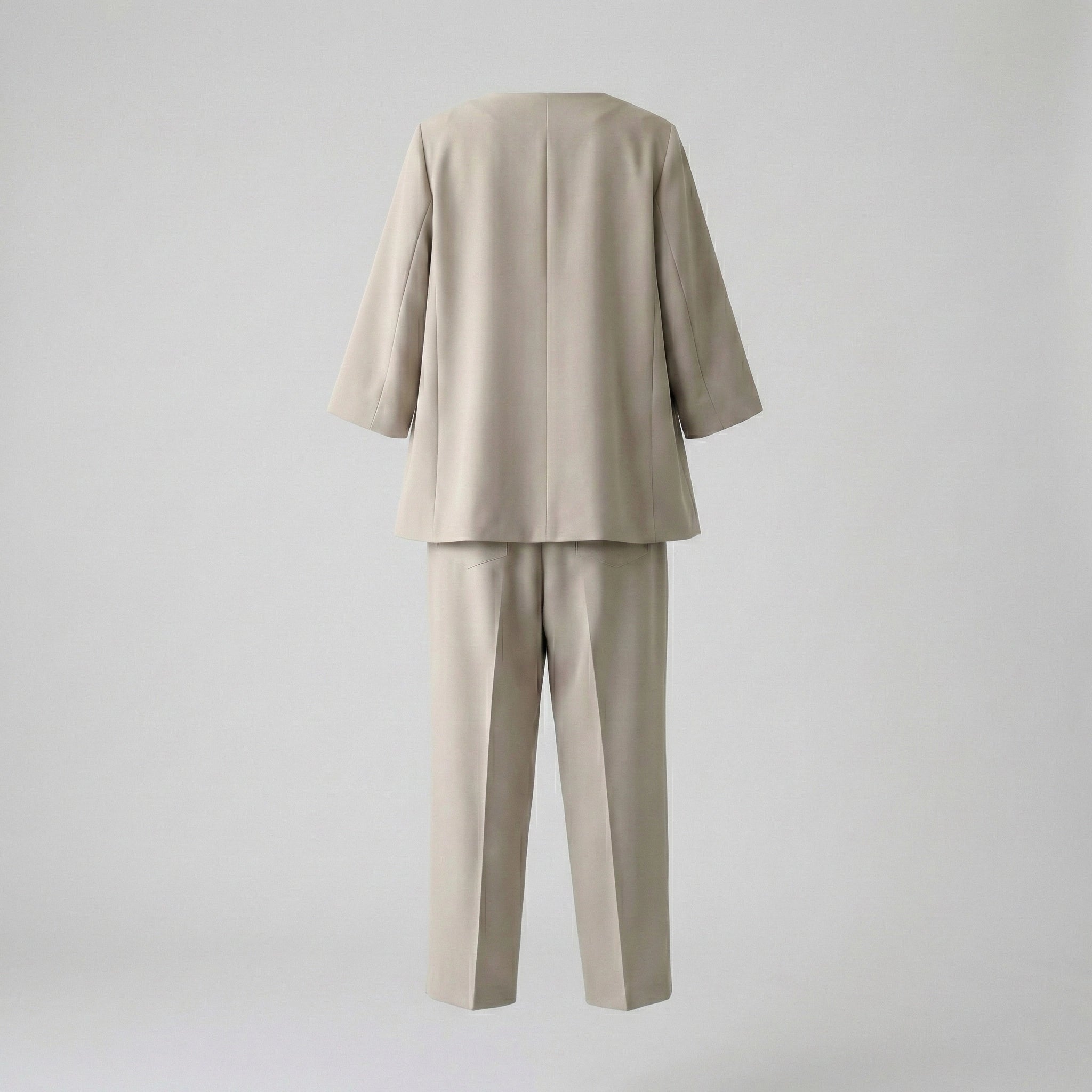 Beige suit with jacket and pants on a light gray background