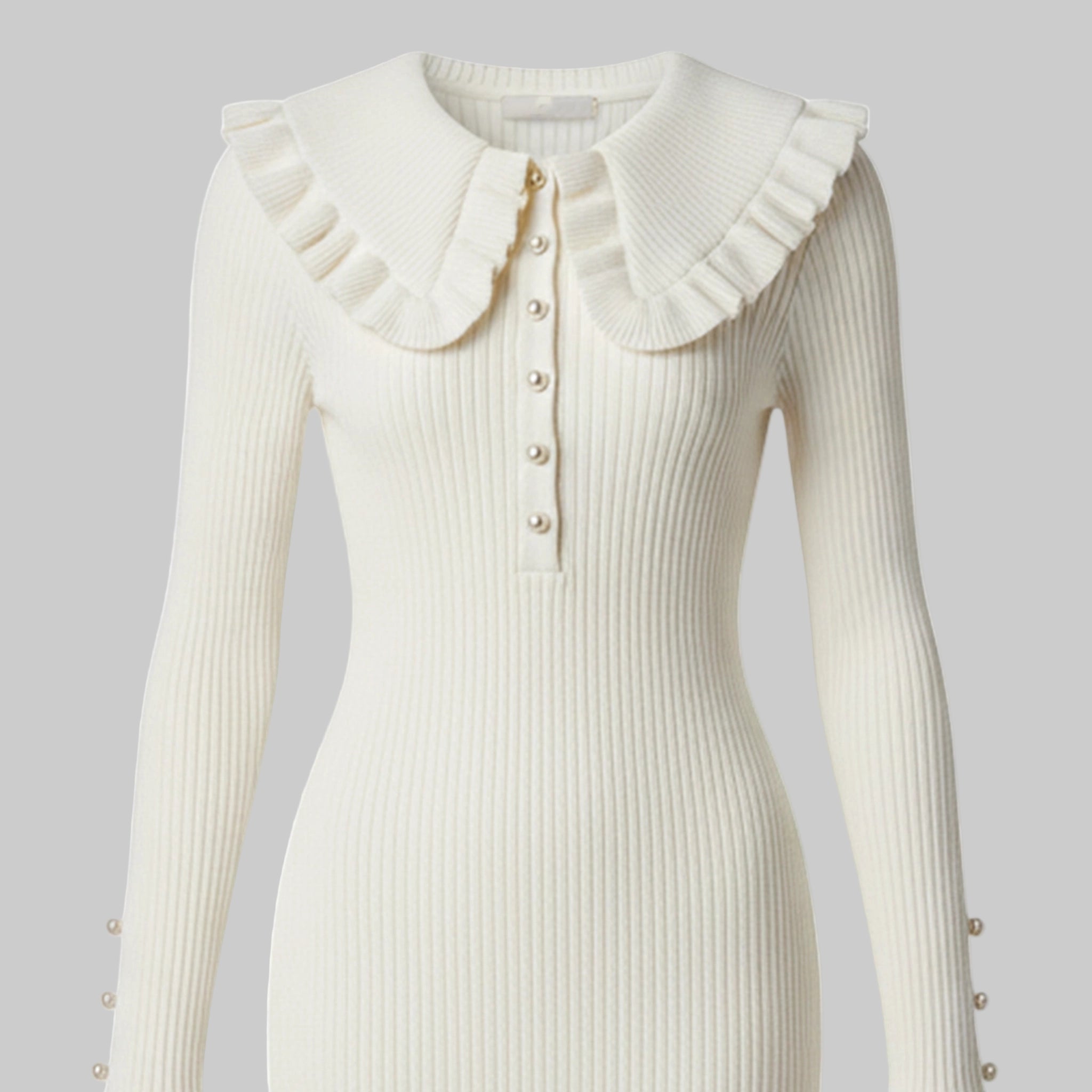 White ribbed dress with ruffled collar and button details on a white background