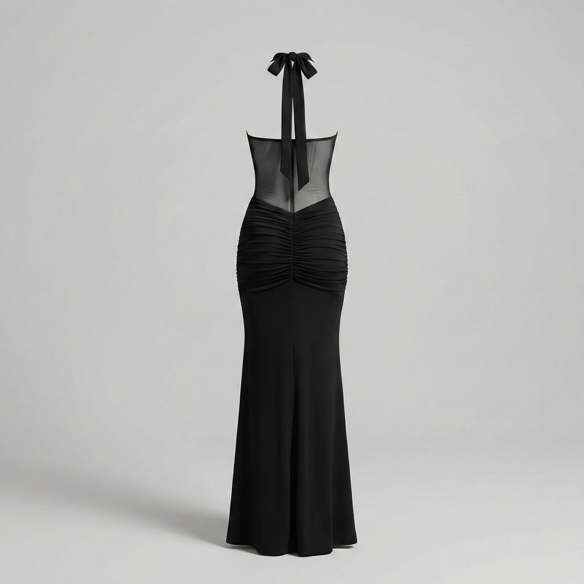 Black evening gown with sheer neckline on a light gray background
