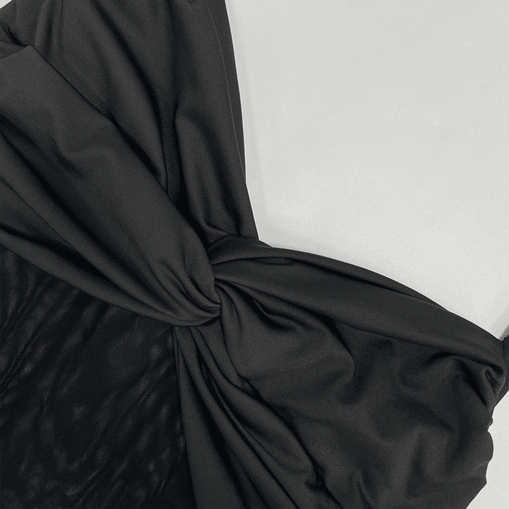 Close-up of black fabric with a knot on a white background