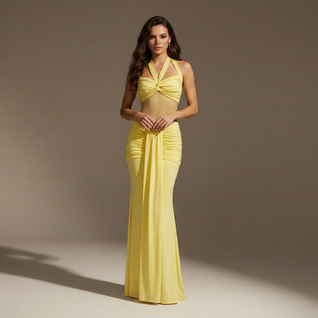 Woman wearing a yellow evening gown against a neutral background