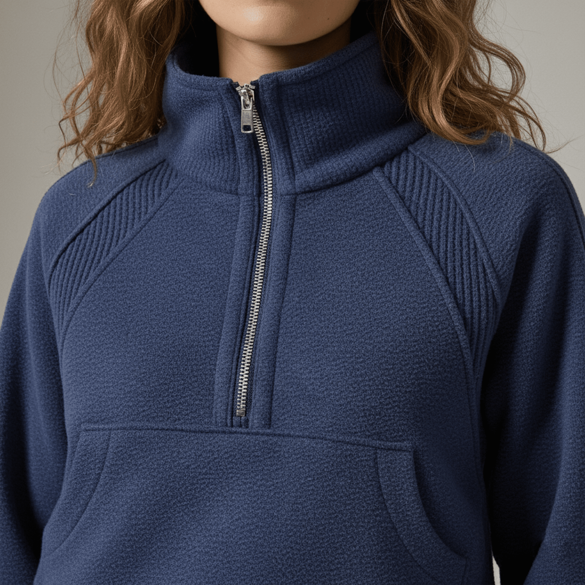 Navy blue pullover with a zipper on a neutral background