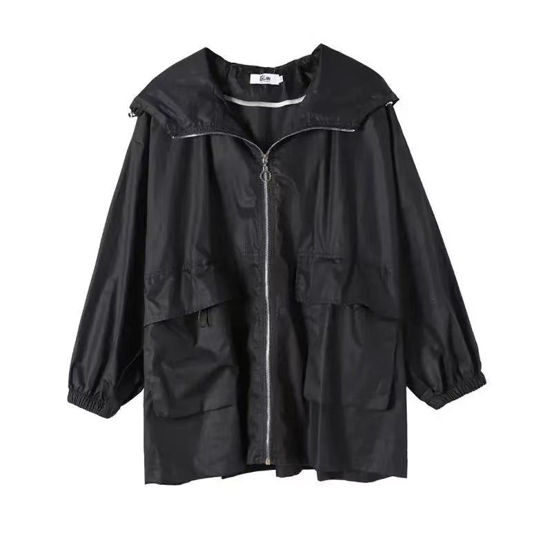 A black lightweight hooded raincoat with a front zipper, elasticized cuffs, and large front pockets, shown against a plain white background.