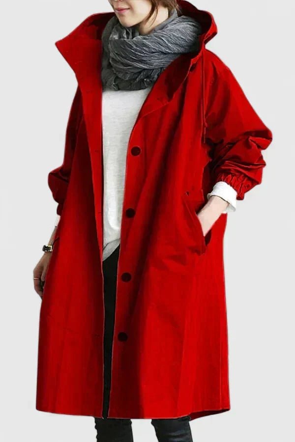 Person wearing a red coat with a hood on a white background