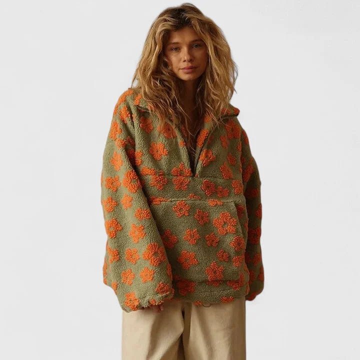 Woman wearing a green and orange floral patterned jacket on a white background