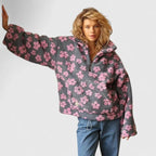 Person wearing a gray floral-patterned sweater on a plain background