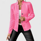 Person wearing a pink textured jacket on a light gray background