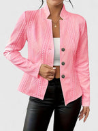 Pink jacket with cable knit pattern worn by a person on a light gray background