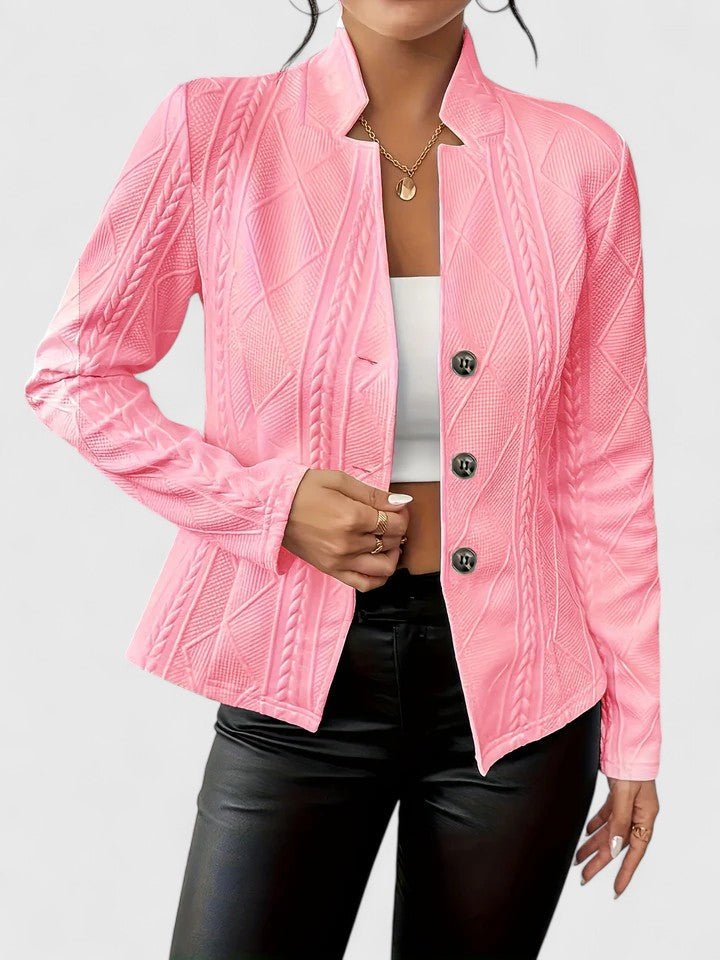 Pink jacket with cable knit pattern worn by a person on a light gray background