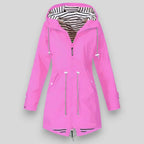 Pink raincoat with zippers on a gray background