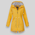 Yellow raincoat with zippers on a gray background