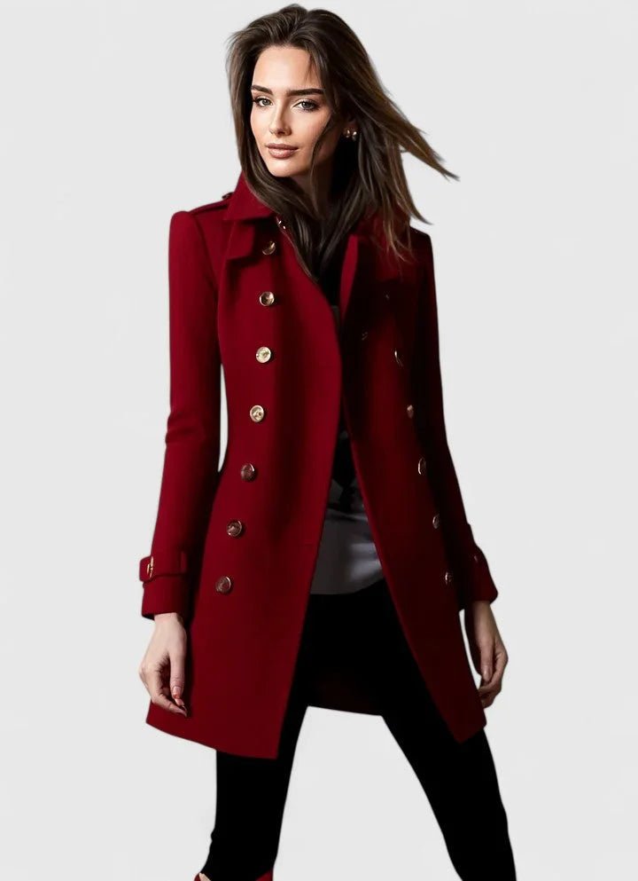Woman wearing a red coat with gold buttons on a white background
