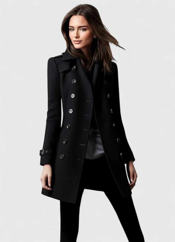 Woman wearing a black coat on a light gray background