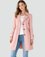 Woman wearing a pink coat on a light gray background