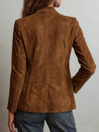 Brown suede jacket worn by a person on a plain background