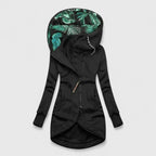 Black hooded jacket with tropical leaf pattern lining on a light gray background