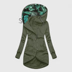 Green hooded jacket with tropical leaf pattern lining on a white background