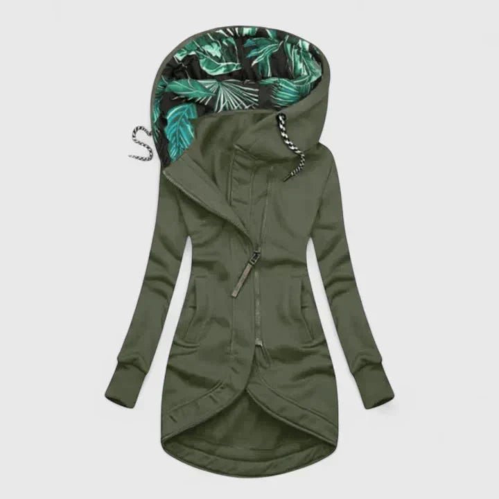 Green hooded jacket with tropical leaf pattern lining on a white background