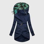 Navy blue hoodie with tropical leaf pattern lining on a light gray background