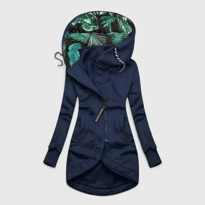 Navy blue hoodie with tropical leaf pattern lining on a light gray background