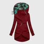 Red hoodie with tropical leaf pattern inside the hood on a light gray background
