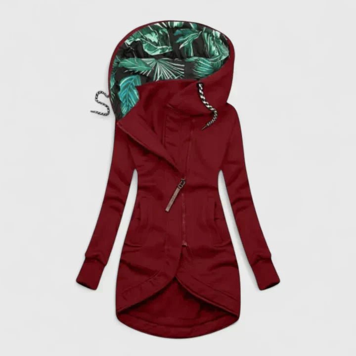 Red hoodie with tropical leaf pattern inside the hood on a light gray background