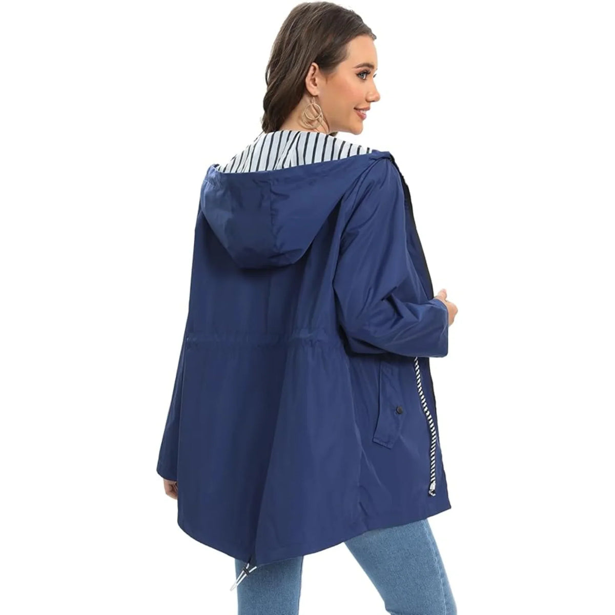 Woman wearing a blue raincoat with a white background