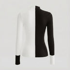 Black and white ribbed sweater on a mannequin against a light gray background