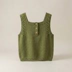 Green knitted tank top with button details on a beige background