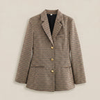 Plaid blazer with gold buttons on a beige background