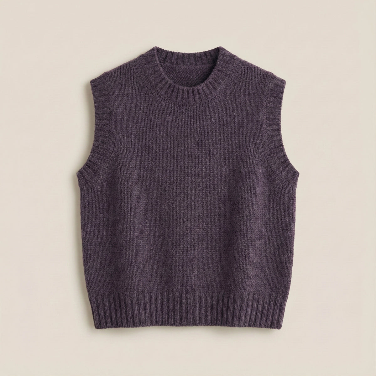 Purple knitted vest on a beige background