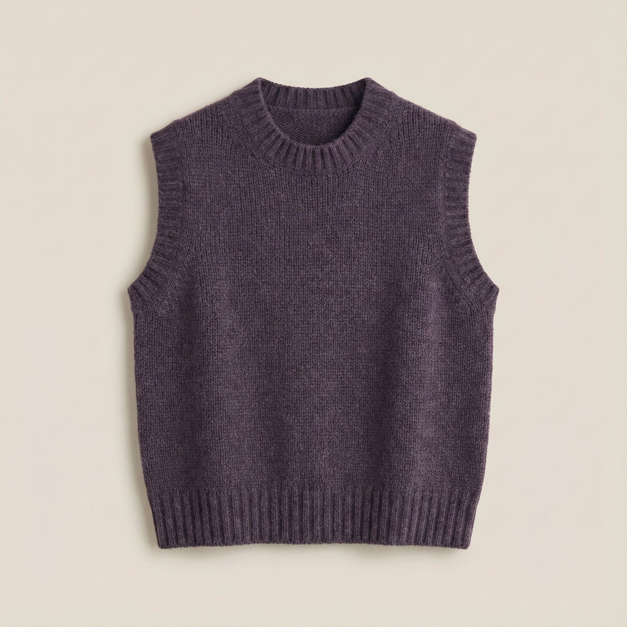 Purple knitted vest on a beige background