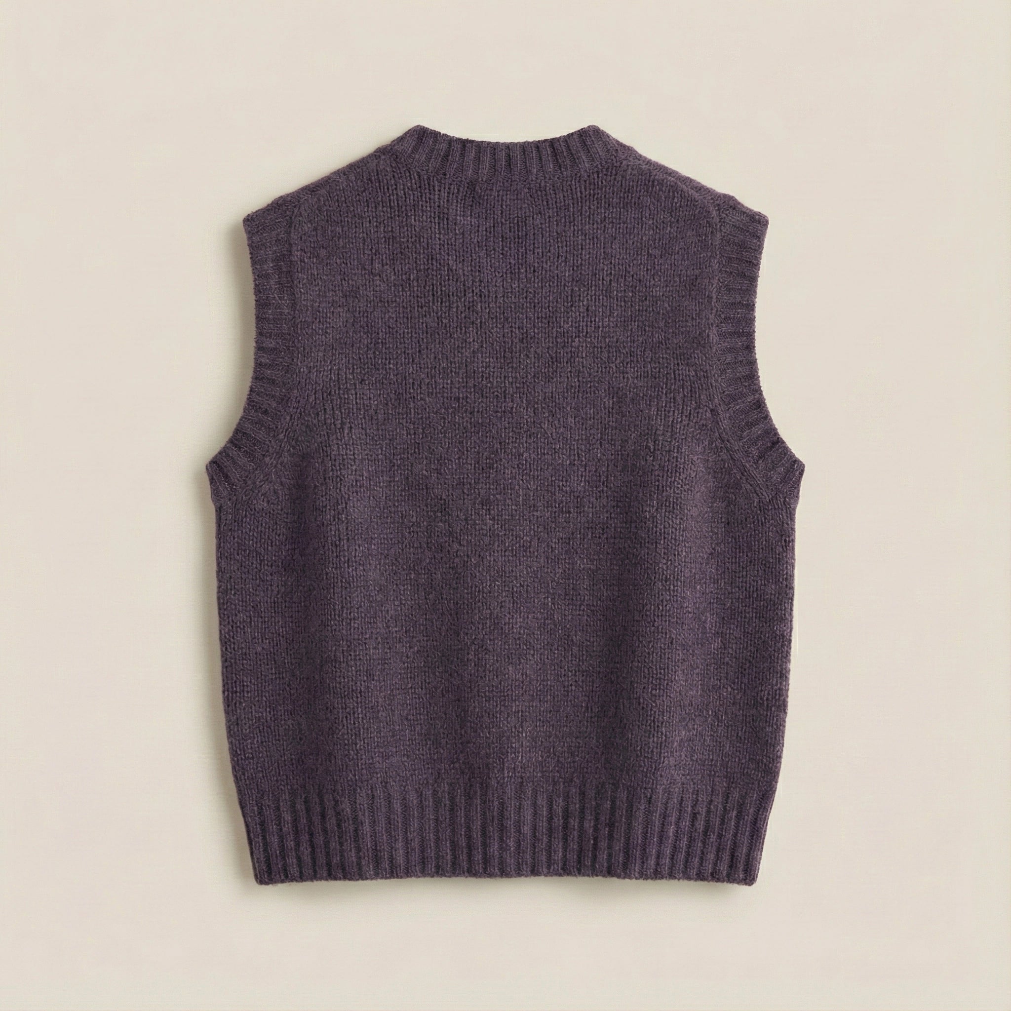 Purple knitted vest on a beige background