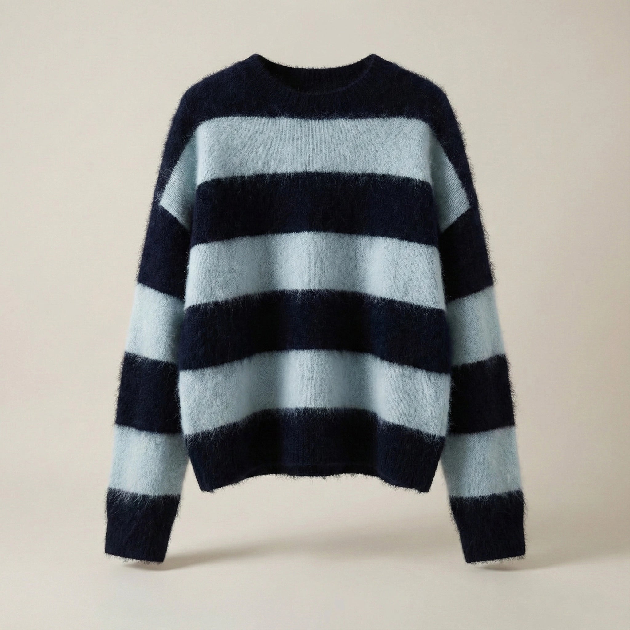Navy and light blue striped sweater on a beige background
