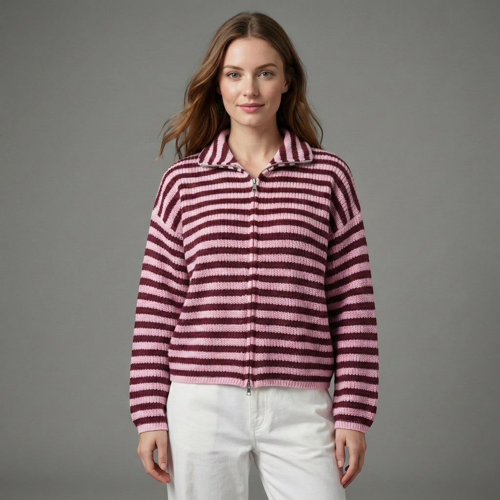Woman wearing a pink and purple striped sweater against a gray background