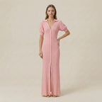 Woman wearing a pink dress with short sleeves on a beige background